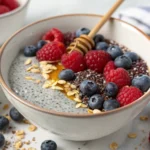 Chia Berry Detox Pudding in a bowl with fresh berries and chia seeds, showcasing its texture and vibrant colors.